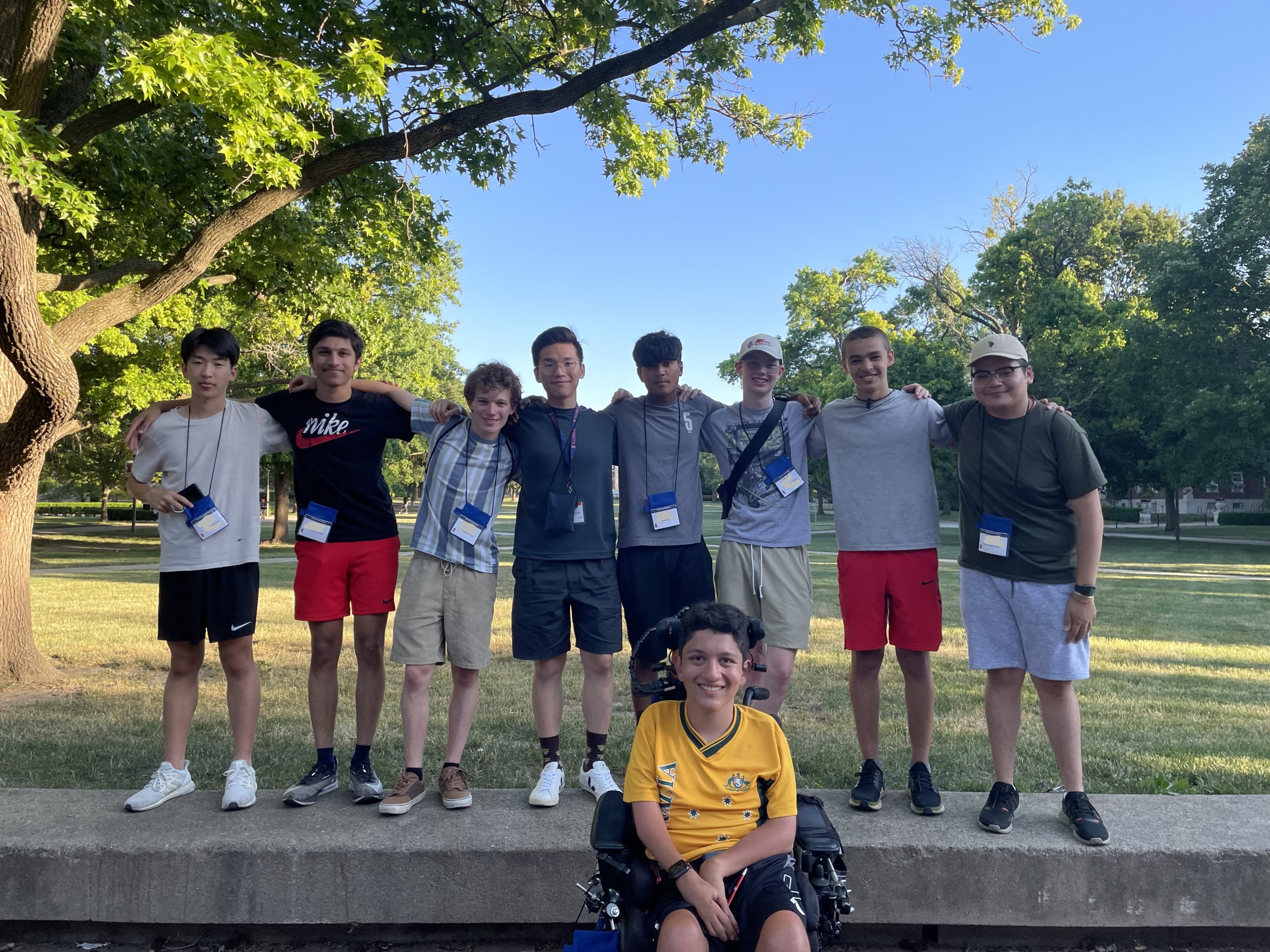 Campers posing for a photo with trees in the background