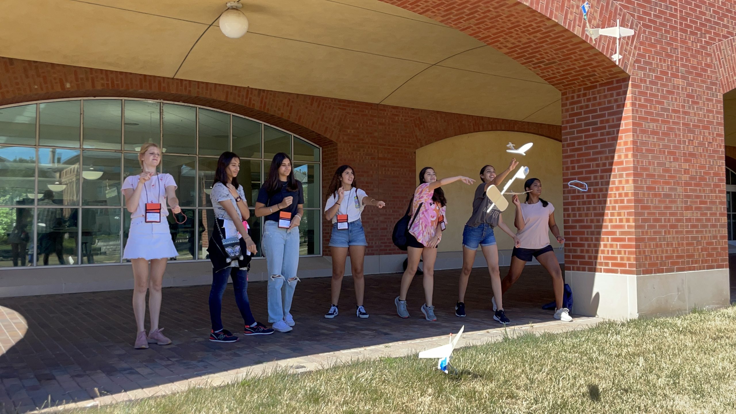 EYO campers flying wooden planes they built outdoors