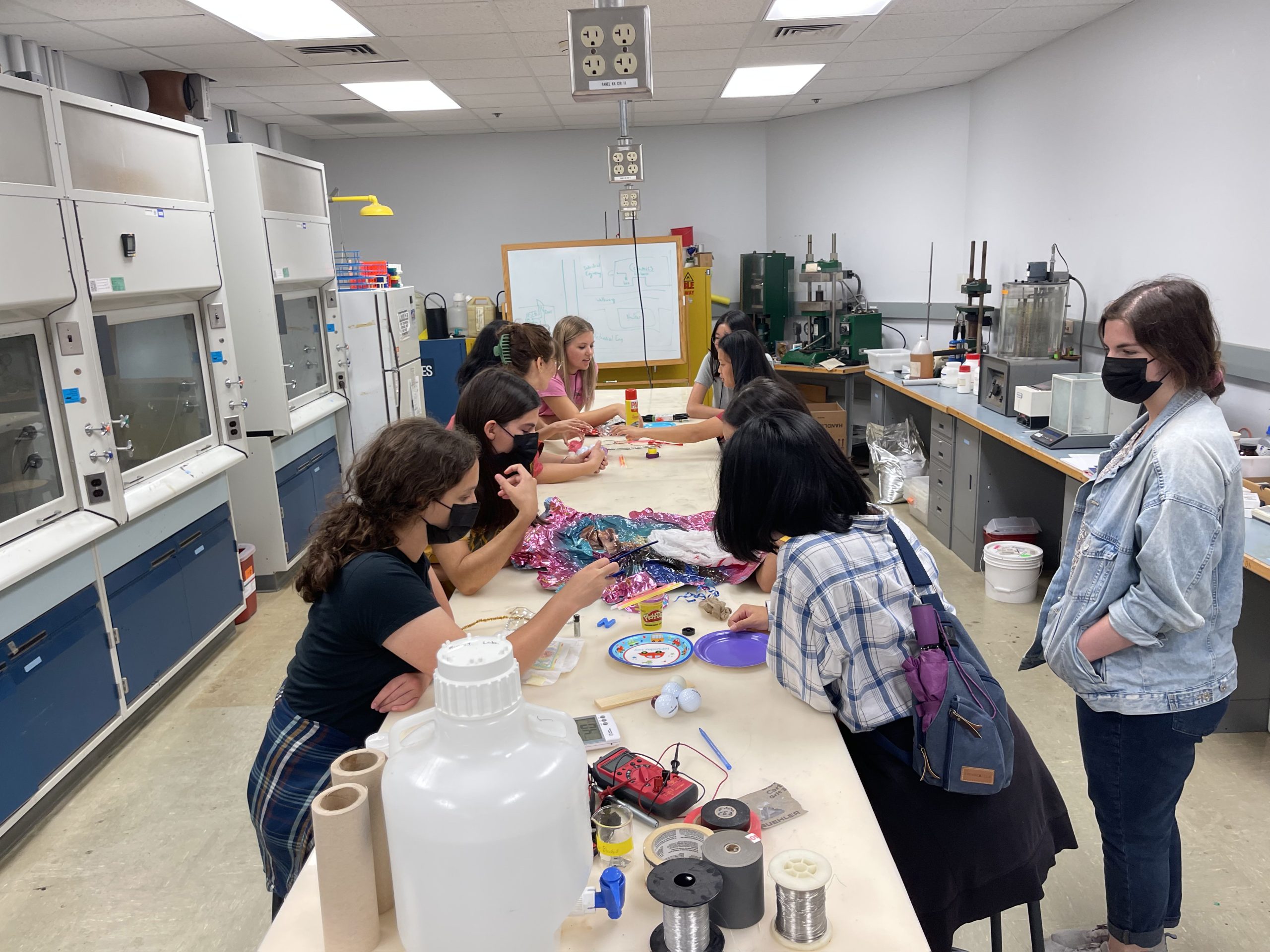 Campers sitting around a table looking and interacting with different materials