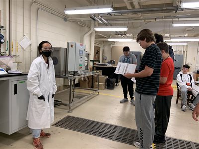 Campers talking to TA in a lab