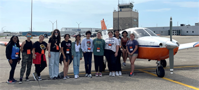 Students standing in front of airplane at the Willard Airport