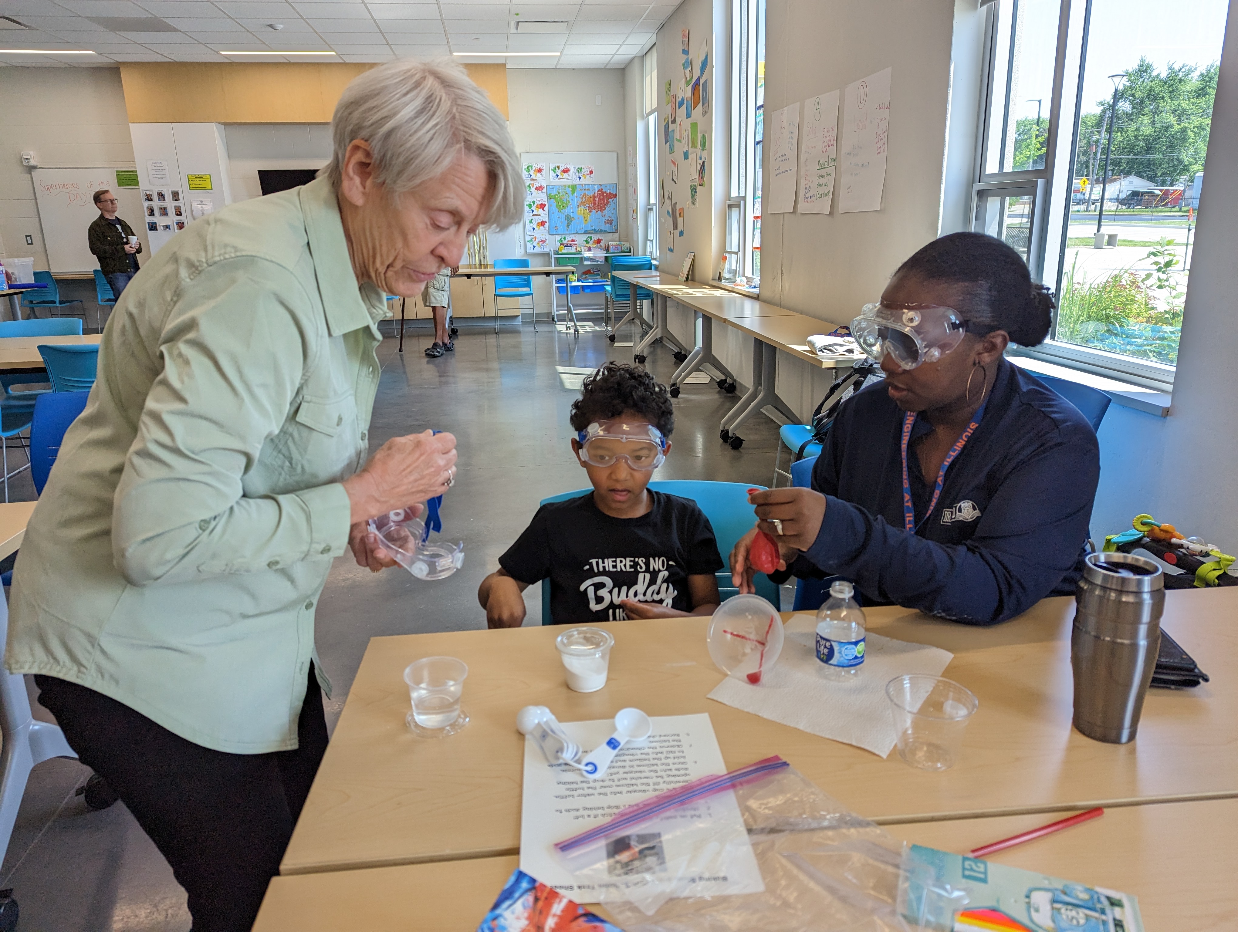 IMAGINE STEM Saturday teacher working with a family on a project