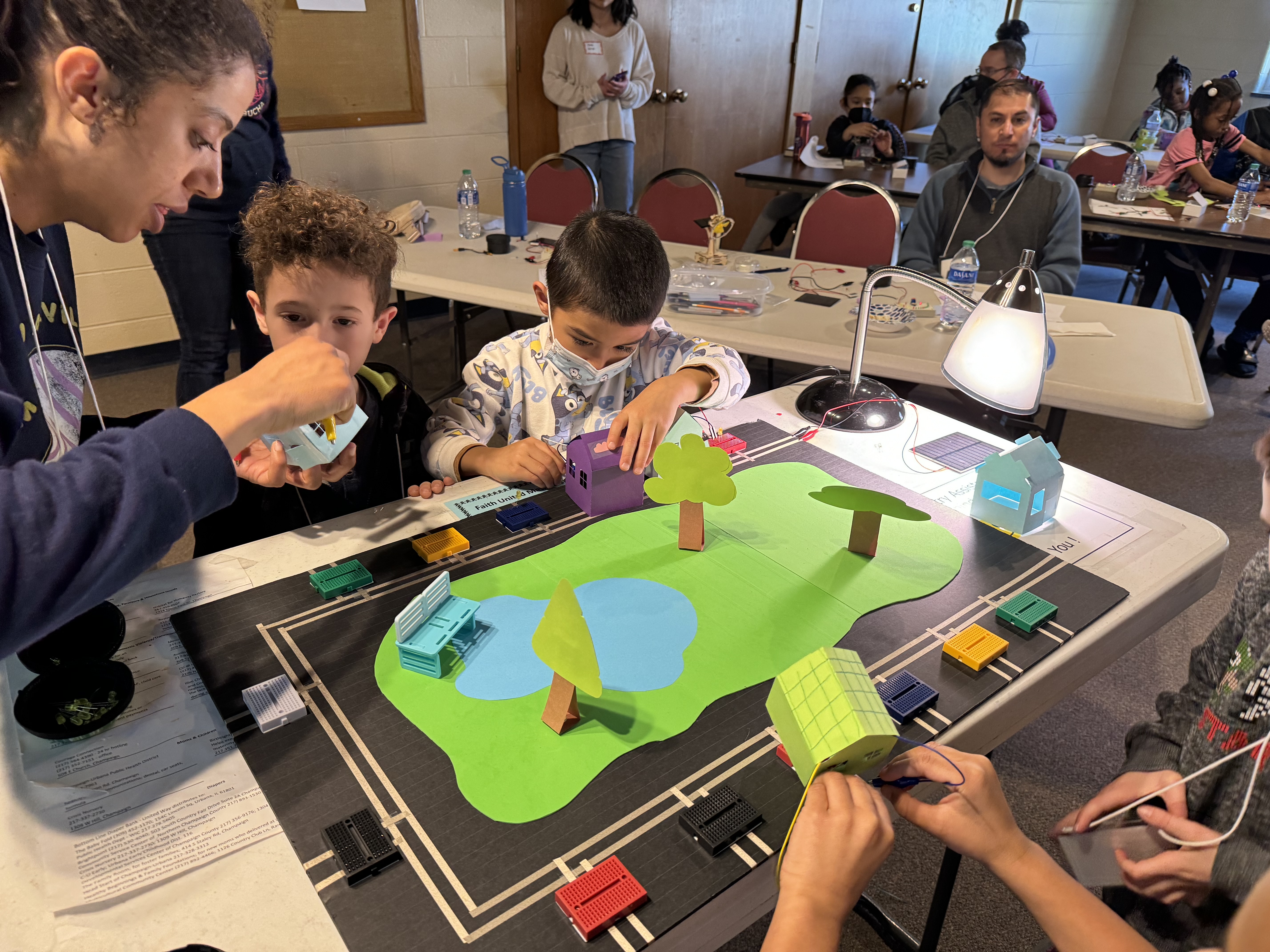 K-2 students and teacher working on solar house activity during an IMAGINE STEM Saturday workshop in Spring 2024.